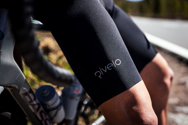 Rivelo bib shorts worn on a ride, showing leg gripper detail and logo in sunlight