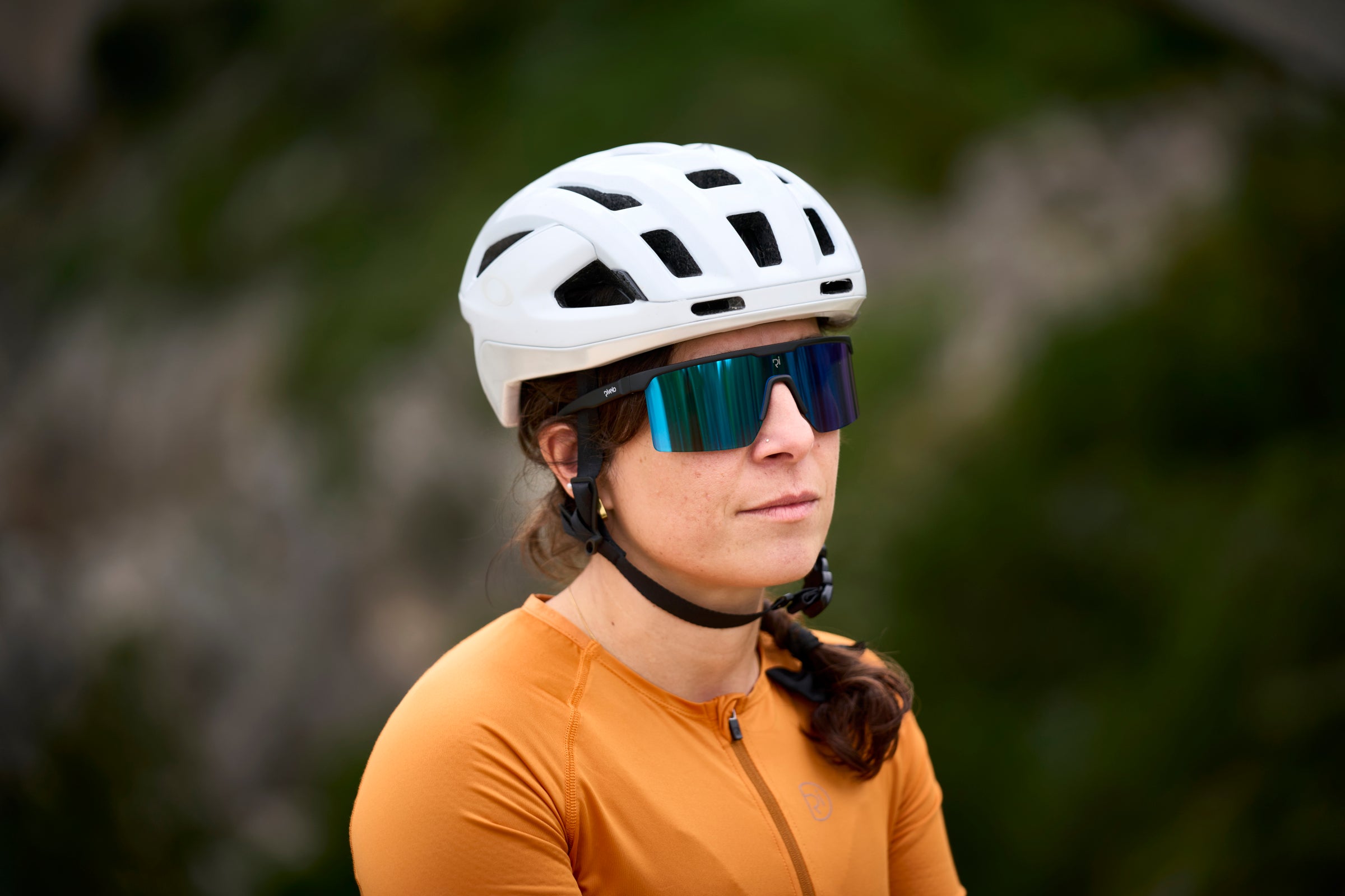 Close-up of a cyclist wearing frameless blue mirror sunglasses