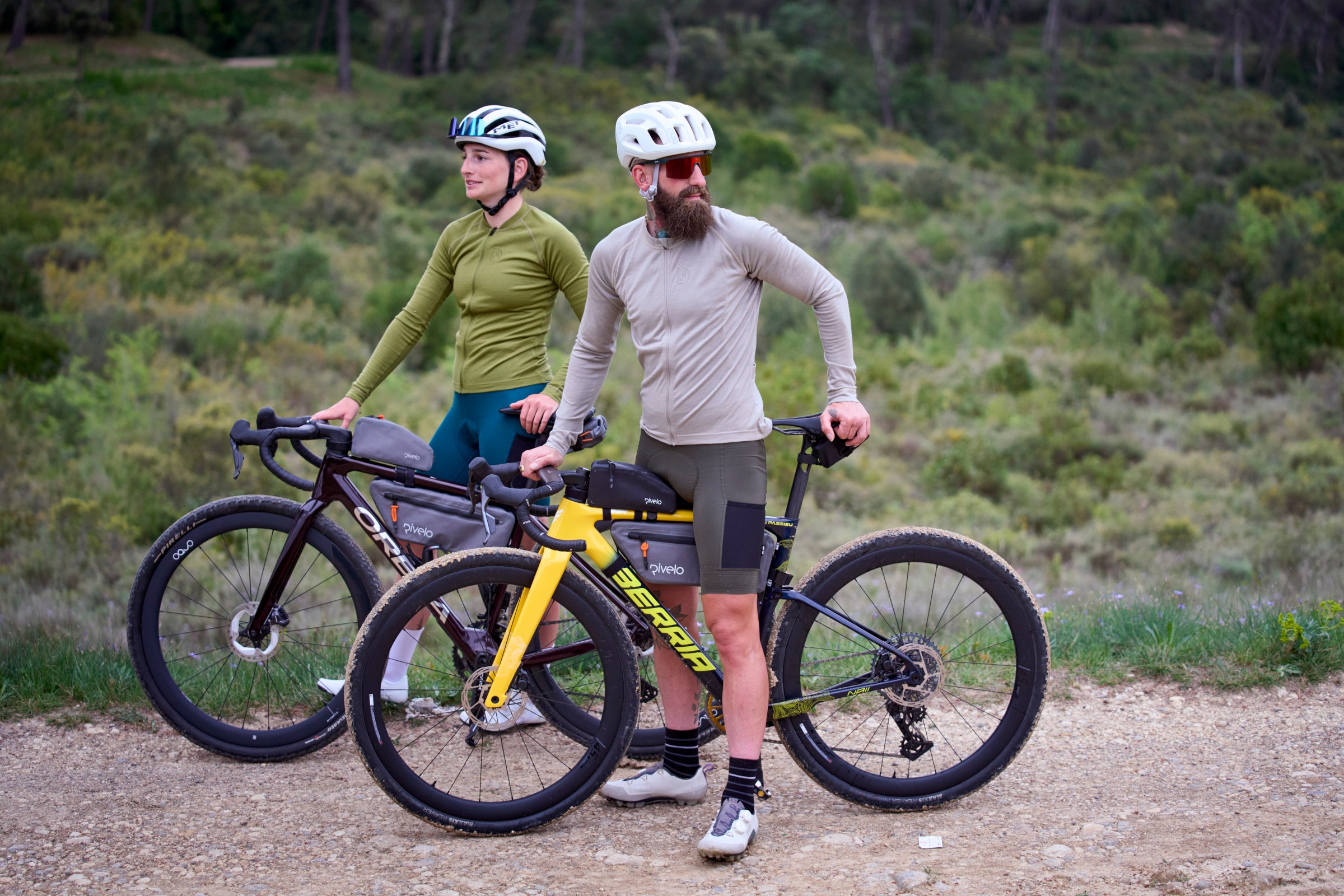 Two cyclists with road and gravel bikes on a dirt track